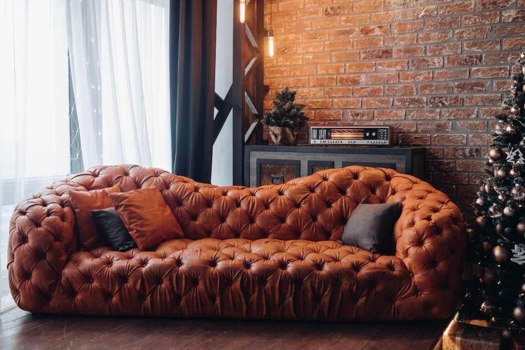 modern-fashionable-red-leather-couch-with-cushions-cropped-christmas-tree-brick-wall-loft-design.jpg